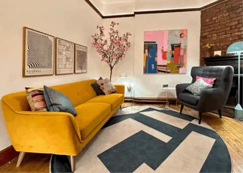 Contemporary hypnotherapy practice featuring comfortable consultation area, modern technology setup, professional credentials displayed, and welcoming client reception space